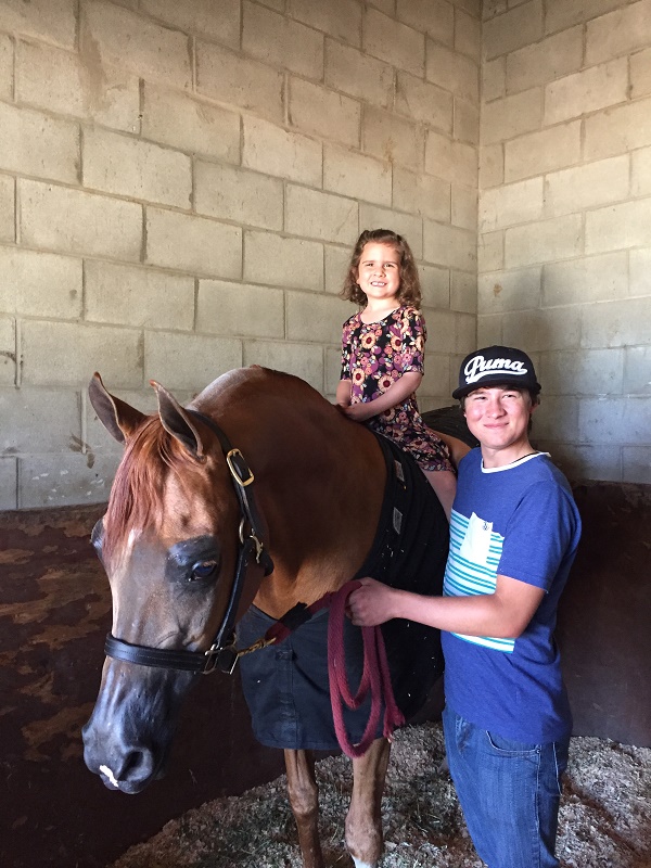 Paediatric cancer patient Layla with Ryan and her Warrior horse,  US National Champion LD Pistal.